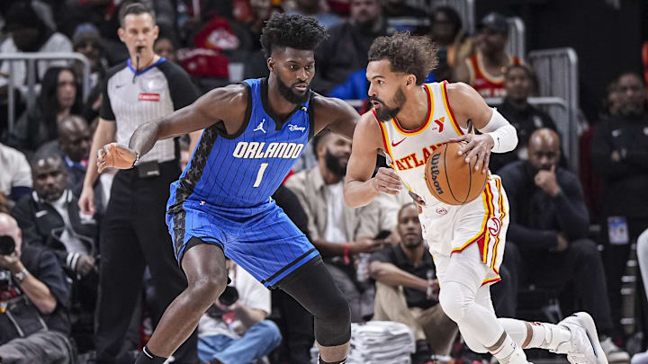 Feb 20, 2025; Atlanta, Georgia, USA; Atlanta Hawks guard Trae Young (11) dribbles against Orlando Magic forward Jonathan Isaac (1) during the first half at State Farm Arena. Mandatory Credit: Dale Zanine-Imagn Images