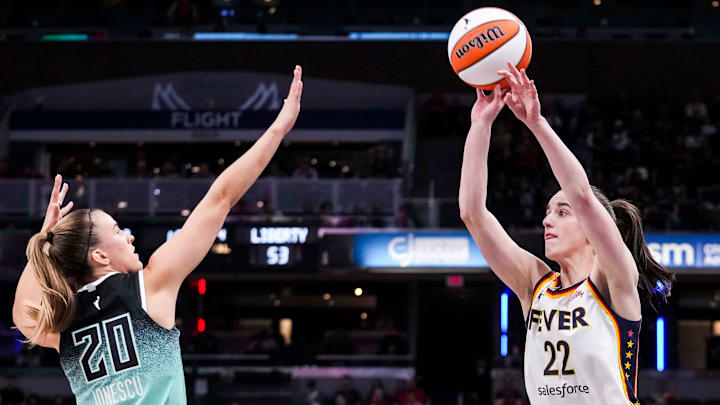 Indiana Fever guard Caitlin Clark (22) attempts a 3-pointer against New York Liberty guard Sabrina Ionescu (20) on Saturday, May 24, 2025, during a game between the Indiana Fever and the New York Liberty at Gainbridge Fieldhouse in Indianapolis.