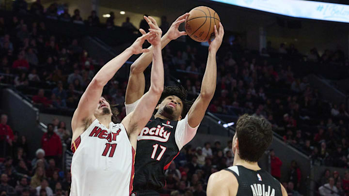 Jan 11, 2025; Portland, Oregon, USA: Portland Trail Blazers guard Shaedon Sharpe (17) grabs a rebound during the second half against Miami Heat guard Jaime Jaquez Jr. (11) at Moda Center. Mandatory Credit: Troy Wayrynen-Imagn Images