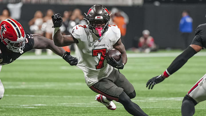 Oct 3, 2024; Atlanta, Georgia, USA; Tampa Bay Buccaneers running back Bucky Irving (7) runs with the ball against the Atlanta Falcons at Mercedes-Benz Stadium. Mandatory Credit: Dale Zanine-Imagn Images