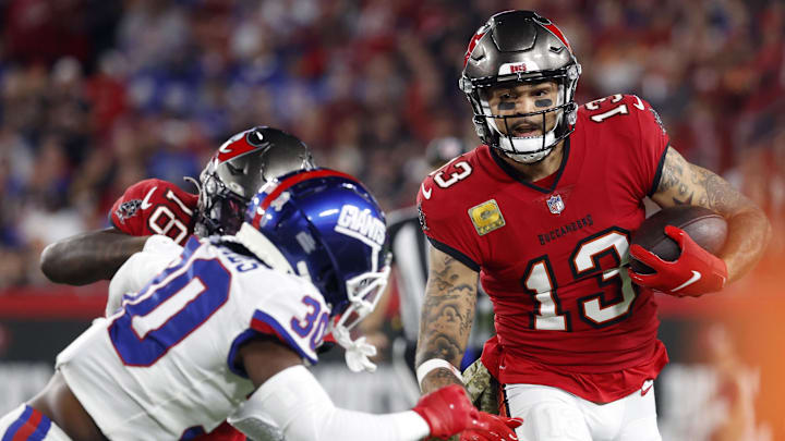 Nov 22, 2021; Tampa, Florida, USA;  Tampa Bay Buccaneers wide receiver Mike Evans (13) runs with the ball as New York Giants cornerback Darnay Holmes (30) defends during the first quarter at Raymond James Stadium. Mandatory Credit: Kim Klement-Imagn Images