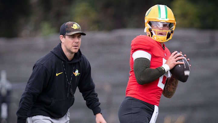 Oregon quarterback Dillon Gabriel throws out a pass as offensive coordinator Will Stein during practice with the Oregon Ducks Tuesday, Aug. 27, 2024 at the Hatfield-Dowlin Complex in Eugene, Ore.
