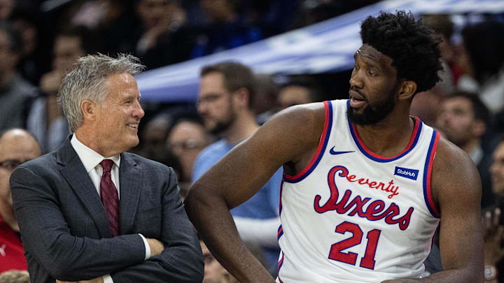 Nov 22, 2019; Philadelphia, PA, USA; Philadelphia 76ers center Joel Embiid (21) and head coach Brett Brown talk during a break in the third quarter of a game against the San Antonio Spurs at Wells Fargo Center. Mandatory Credit: Bill Streicher-Imagn Images