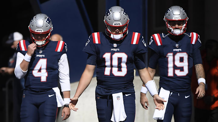 Oct 8, 2023; Foxborough, Massachusetts, USA; New England Patriots quarterback Bailey Zappe (4) quarterback Mac Jones (10) and quarterback Will Grier (19) walk out of the tunnel prior to a game against the New Orleans Saints at Gillette Stadium.