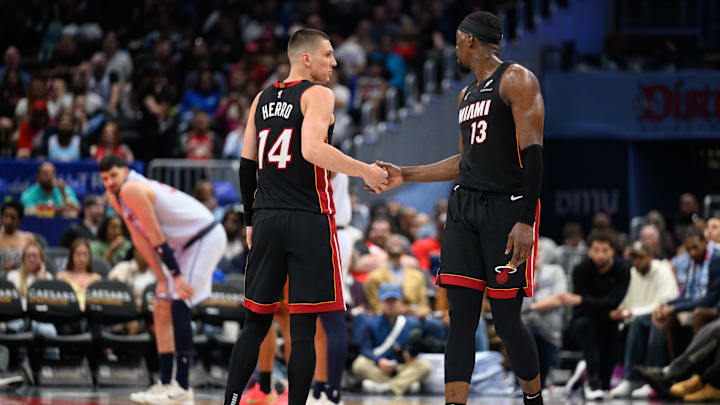 Mar 31, 2025; Washington, District of Columbia, USA; Miami Heat guard Tyler Herro (14) and center Bam Adebayo (13) react during the third quarter against the Washington Wizards at Capital One Arena. Mandatory Credit: Reggie Hildred-Imagn Images