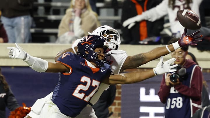 Nov 29, 2025; Charlottesville, Virginia, USA; Virginia Tech Hokies tight end Ja'Ricous Hairston (13) attempts to catch a pass as Virginia Cavaliers safety Devin Neal (27) defendds in the first quarter at Scott Stadium. Mandatory Credit: Geoff Burke-Imagn Images