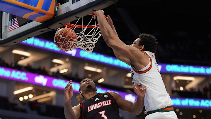 Mar 12, 2026; Charlotte, NC, USA; Miami (FL) Hurricanes forward Malik Reneau (5) makes a slam dunk against Louisville Cardinals guard Ryan Conwell (3) during the first half at Spectrum Center. Mandatory Credit: Jim Dedmon-Imagn Images