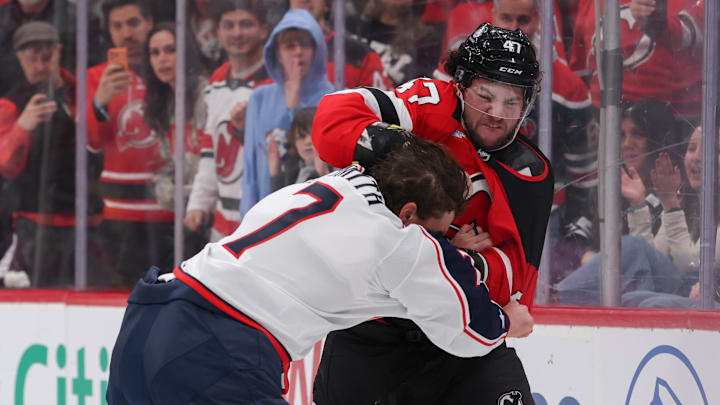 Dec 1, 2025; Newark, New Jersey, USA; New Jersey Devils left wing Paul Cotter (47) and Columbus Blue Jackets defenseman Brendan Smith (7) fight during the second period at Prudential Center. Mandatory Credit: Ed Mulholland-Imagn Images