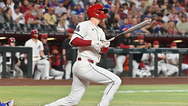 Mar 28, 2025; Phoenix, Arizona, USA; Arizona Diamondbacks outfielder Pavin Smith (26) singles in the second inning against the Chicago Cubs at Chase Field. Mandatory Credit: Matt Kartozian-Imagn Images Mar 28, 2025; Phoenix, Arizona, USA; Arizona Diamondbacks outfielder Pavin Smith (26) singles in the second inning against the Chicago Cubs at Chase Field. Mandatory Credit: Matt Kartozian-Imagn Images