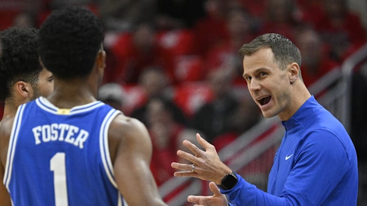 Jan 6, 2026; Louisville, Kentucky, USA;  Duke Blue Devils head coach Jon Scheyer talks with Duke Blue Devils guard Cayden Boozer (2) and guard Caleb Foster (1) against the Louisville Cardinals.