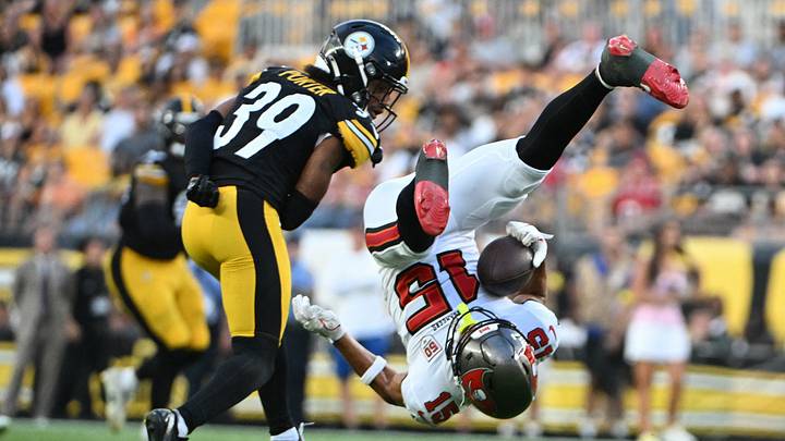 Aug 16, 2025; Pittsburgh, Pennsylvania, USA; Tampa Bay Buccaneers wide receiver Jalen McMillan (15) makes a catch against Pittsburgh Steelers cornerback Daryl Porter Jr. (39) during the first quarter at Acrisure Stadium. Mandatory Credit: Barry Reeger-Imagn Images