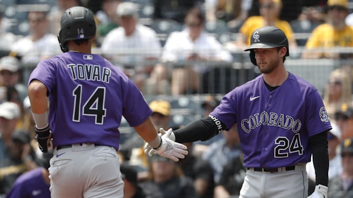 Pittsburgh, Pennsylvania, USA;  Colorado Rockies shortstop Ezequiel Tovar (14) is congratulated by third baseman Ryan McMahon (24) after Tovar scored a run against the Pittsburgh Pirates during the fourth inning at PNC Park.