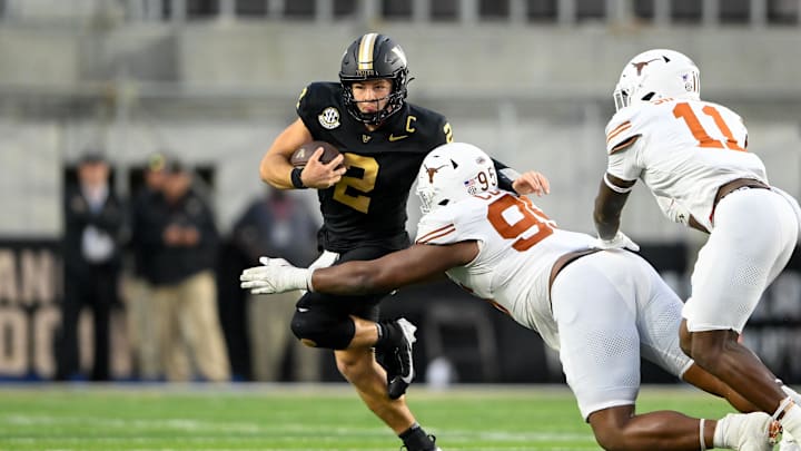 Oct 26, 2024; Nashville, Tennessee, USA;  Texas Longhorns defensive lineman Alfred Collins (95) tackles Vanderbilt Commodores quarterback Diego Pavia (2) for a loss during the second half at FirstBank Stadium. Mandatory Credit: Steve Roberts-Imagn Images