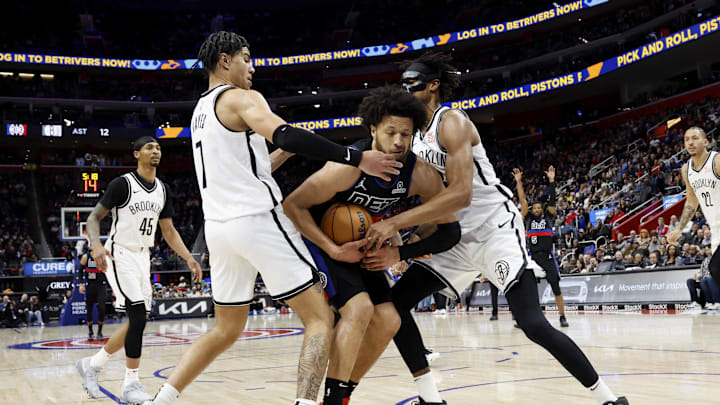 Mar 1, 2025; Detroit, Michigan, USA;  Brooklyn Nets guard Killian Hayes (7) and center Nic Claxton (33) try to tie up Detroit Pistons guard Cade Cunningham (2) in the second half at Little Caesars Arena. Mandatory Credit: Rick Osentoski-Imagn Images