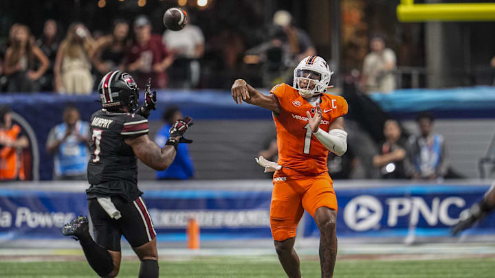 Aug 31, 2025; Atlanta, Georgia, USA; Virginia Tech Hokies quarterback Kyron Drones (1) passes over South Carolina Gamecocks linebacker Shawn Murphy (7) during the second half at Mercedes-Benz Stadium. Mandatory Credit: Dale Zanine-Imagn Images