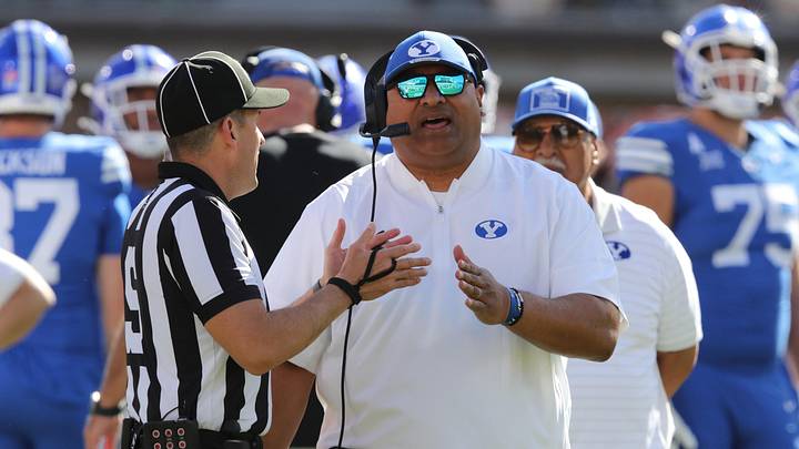 Nov 8, 2025; Lubbock, Texas, USA;  Brigham Young Cougars head coach Kalani Sitake discusses a call with Big 12 official Randy Smith in the second half of the game against the Texas Tech Red Raiders at Jones AT&T Stadium. Mandatory Credit: Michael C. Johnson-Imagn Images