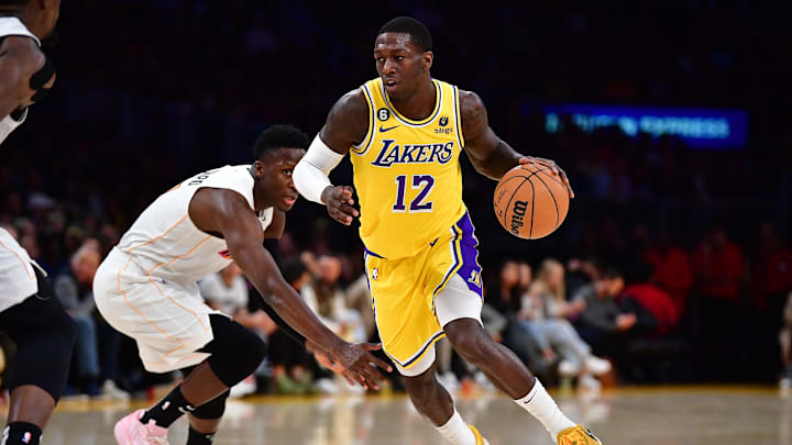 Jan 4, 2023; Los Angeles, California, USA; Los Angeles Lakers guard Kendrick Nunn (12) moves the ball ahead of Miami Heat guard Victor Oladipo (4) during the second half at Crypto.com Arena.