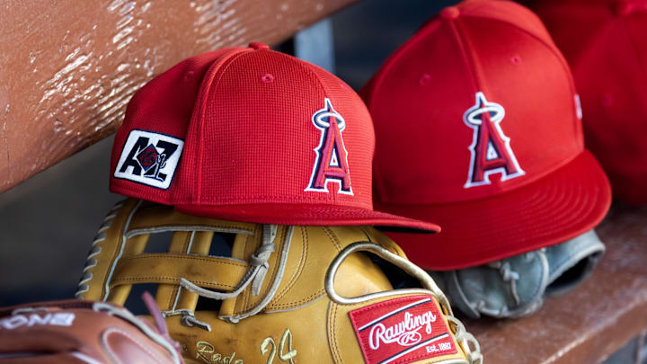 Feb 28, 2025; Phoenix, Arizona, USA; Detailed view of the Los Angeles Angels logo on a hat in the dugout during a spring training game at Camelback Ranch-Glendale. Mandatory Credit: Mark J. Rebilas-Imagn Images Feb 28, 2025; Phoenix, Arizona, USA; Detailed view of the Los Angeles Angels logo on a hat in the dugout during a spring training game at Camelback Ranch-Glendale. Mandatory Credit: Mark J. Rebilas-Imagn Images