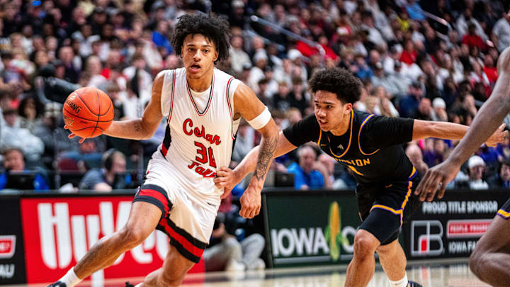 Cedar Fall's Jaydon Kimbrough (30) drives to the basket past Johnston's Nicare Cavil (1) on March 13, 2026, at Casey’s Center in Des Moines.