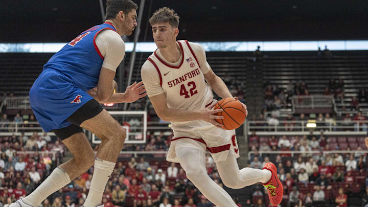 Mar 1, 2025; Stanford, California, USA;  Stanford Cardinal forward Maxime Raynaud (42) drives the ball during the first half against Southern Methodist Mustangs center Samet Yigitoglu (24) at Maples Pavilion. Mandatory Credit: Stan Szeto-Imagn Images