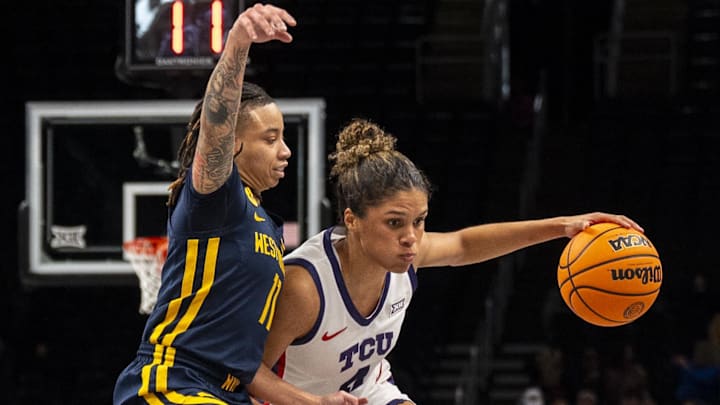 Mar 8, 2025; Kansas City, MO, USA; TCU Horned Frogs guard Donovyn Hunter (4) handles the ball while defended by West Virginia Mountaineers guard JJ Quinerly (11) during the first half at T-Mobile Center. Mandatory Credit: Amy Kontras-Imagn Images