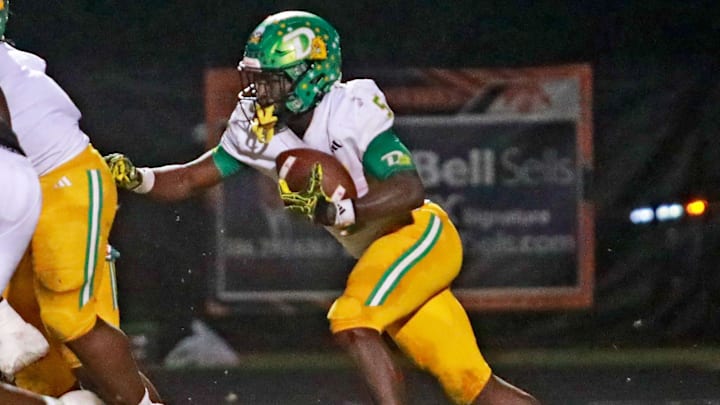 DeLand’s Taihj Moore (5) pushes through players against Spruce Creek in the Class 7A, District 2 title game on Nov. 4. The Bulldogs won 42-0 and earned a No. 1 seed for this week's regional playoffs.