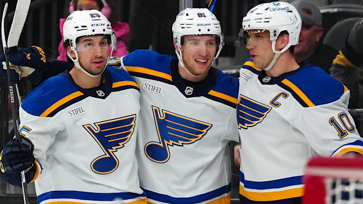 Jan 20, 2025; Las Vegas, Nevada, USA; St. Louis Blues center Brayden Schenn (10) celebrates with center Dylan Holloway (81) and center Jordan Kyrou (25) after scoring a goal against the Vegas Golden Knights during the first period at T-Mobile Arena. Mandatory Credit: Stephen R. Sylvanie-Imagn Images