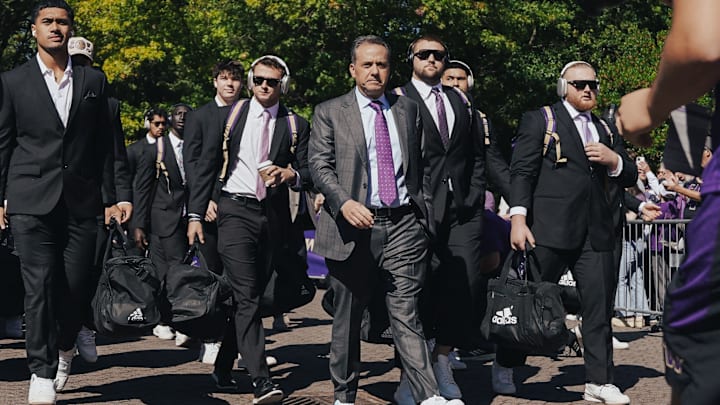Jedd Fisch leads his UW football team into the stadium on game day. Jedd Fisch leads his UW football team into the stadium on game day.