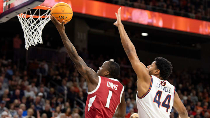 Arkansas Razorbacks guard Johnell Davis (1) goes up for a layup over Auburn Tigers center Dylan Cardwell (44) as Auburn Tigers take on Arkansas Razorbacks at Neville Arena in Auburn, Ala., on Wednesday, Feb. 19, 2025.