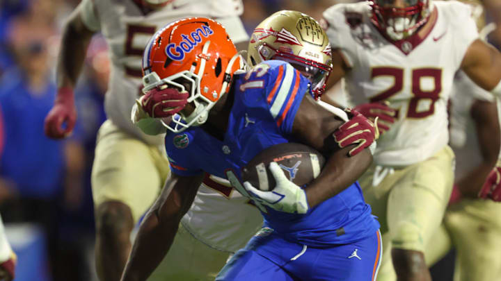 Florida running back Jadan Baugh (13) gets face masked during the second half of an NCAA football game at Steve Spurrier Field at Ben Hill Griffin Stadium in Gainesville, FL on Saturday, November 29, Florida beat Florida State 40-21.2025. [Alan Youngblood/Gainesville Sun]