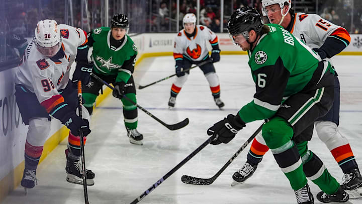 Coachella Valley forward Logan Morrison passes the puck down the boards as Texas defenseman Lian Bichsel closes in on him during the first period of their game at Acrisure Arena in Palm Desert, Calif., Thursday, Dec. 5, 2024.