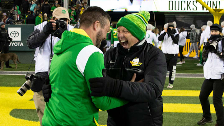 Dan Lanning and Rob Mullens celebrate a win at Autzen Stadium. Judge Claudia Wilkins approved the House Settlement Friday night, a decision that creates new challenges for college sports.