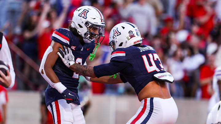 Nov 8, 2025; Tucson, Arizona, USA; Arizona Wildcats defensive backs Treydan Stukes and Dalton Johnson celebrate a win against the Kansas Jayhawks at the end of the game at Arizona Stadium. Mandatory Credit: Aryanna Frank-Imagn Images