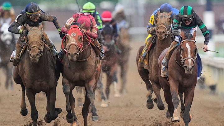 Near the finish line, jockey Tyler Gaffalione, left, and Forever Young's jockey Ryusei Sakai crowd after the two horses bumped and Mystik Dan with jockey Brian J. Hernandez, right, won the 2024 Kentucky Derby at Churchill Downs Saturday, May 4, 2024 in Louisville, Kentucky.