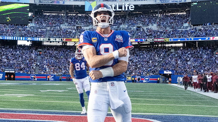 Nov 3, 2024; East Rutherford, New Jersey, USA; New York Giants quarterback Daniel Jones (8) celebrates after scoring a 2nd half touchdown against the Washington Commanders at MetLife Stadium.  