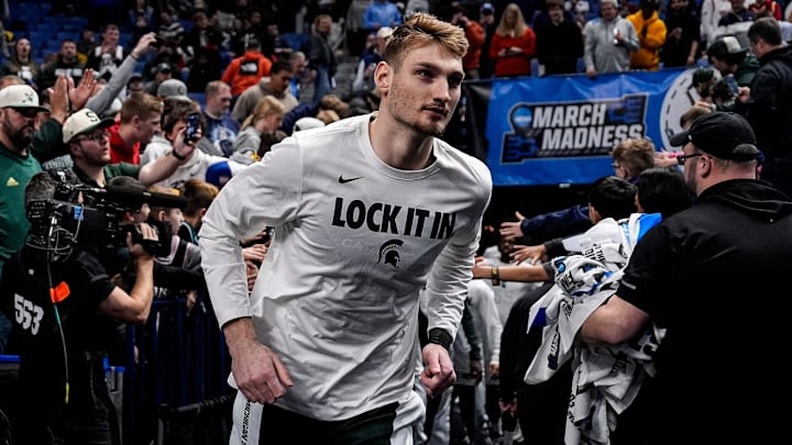 Michigan State center Carson Cooper (15) runs onto the court for warm upl ahead of the game between Michigan State and North Dakota State at the NCAA Tournament First Round at KeyBank Center in Buffalo on Thursday, March 19, 2026.