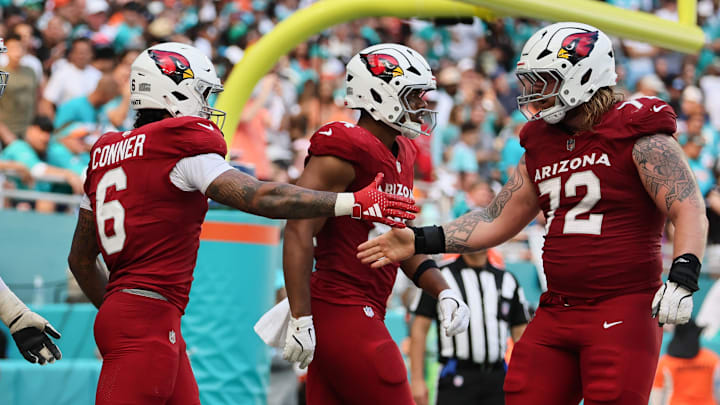 Oct 27, 2024; Miami Gardens, Florida, USA; Arizona Cardinals running back James Conner (6) celebrates with guard Hjalte Froholdt (72) after scoring a touchdown against the Miami Dolphins during the fourth quarter at Hard Rock Stadium. Mandatory Credit: Sam Navarro-Imagn Images Oct 27, 2024; Miami Gardens, Florida, USA; Arizona Cardinals running back James Conner (6) celebrates with guard Hjalte Froholdt (72) after scoring a touchdown against the Miami Dolphins during the fourth quarter at Hard Rock Stadium. Mandatory Credit: Sam Navarro-Imagn Images