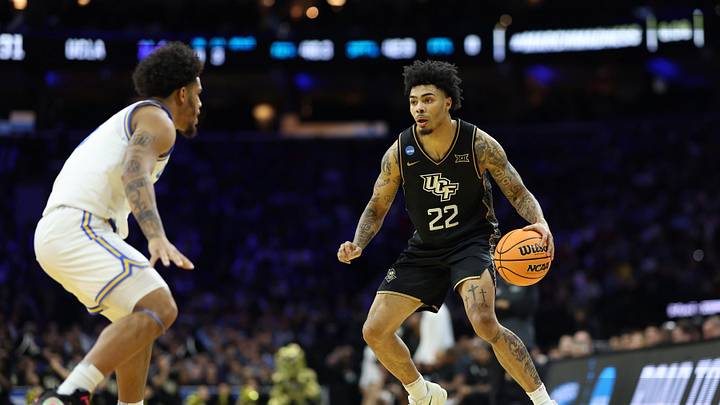 Mar 20, 2026; Philadelphia, PA, USA; UCF Knights guard Chris Johnson (22) dribbles the ball against the UCLA Bruins in the first half during a first round game of the men's 2026 NCAA Tournament at Xfinity Mobile Arena. Mandatory Credit: Bill Streicher-Imagn Images