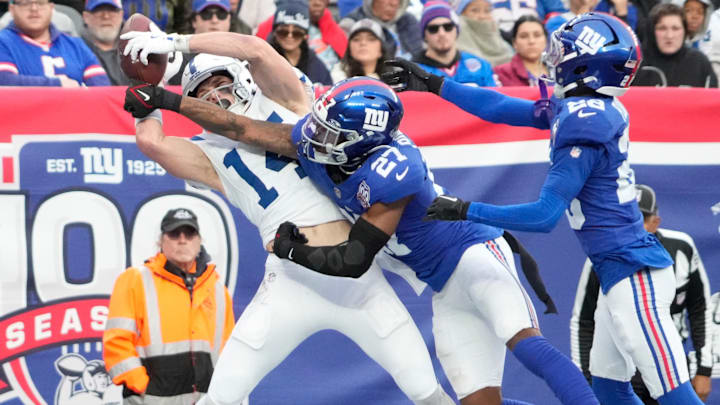 Dec 29, 2024; East Rutherford, New Jersey, USA; Indianapolis Colts wide receiver Alec Pierce (14) scores a 4th quarter touchdown as New York Giants safety Jason Pinnock (27) and cornerback Cor'Dale Flott (28) defend at MetLife Stadium. Dec 29, 2024; East Rutherford, New Jersey, USA; Indianapolis Colts wide receiver Alec Pierce (14) scores a 4th quarter touchdown as New York Giants safety Jason Pinnock (27) and cornerback Cor'Dale Flott (28) defend at MetLife Stadium.