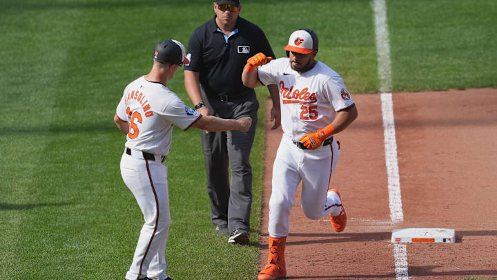 Sep 19, 2024; Baltimore, Maryland, USA; Baltimore Orioles designated hitter Anthony Santander (25) greeted by third base coach Tony Mansolino (36) following his game winning two run home run in the ninth inning against the San Francisco Giants at Oriole Park at Camden Yards.