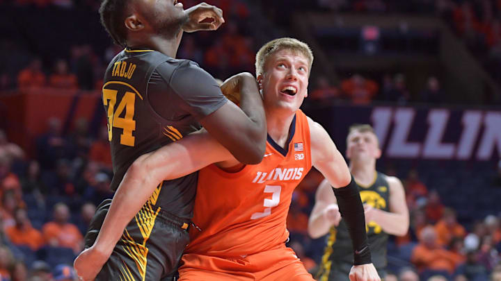 Feb 25, 2025; Champaign, Illinois, USA;  Iowa Hawkeyes forward Chris Tadjo (34) and Illinois Fighting Illini forward Ben Humrichous (3) battle for position during the second half at State Farm Center. Mandatory Credit: Ron Johnson-Imagn Images