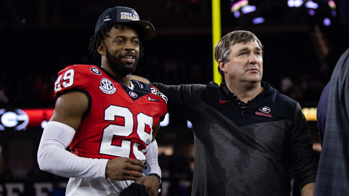 Jan 9, 2023; Inglewood, CA, USA; Georgia Bulldogs defensive back Christopher Smith (29) celebrates with head coach Kirby Smart after defeating the TCU Horned Frogs during the CFP national championship game at SoFi Stadium. Mandatory Credit: Mark J. Rebilas-Imagn Images