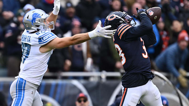  Jaylon Johnson intercepts a pass intended for Detroit Lions tight end Sam LaPorta in 2023.