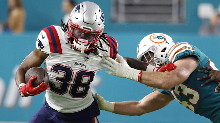 Miami Dolphins linebacker Andrew Van Ginkel (43) tackles New England Patriots running back Rhamondre Stevenson (38) during the third quarter at Hard Rock Stadium.