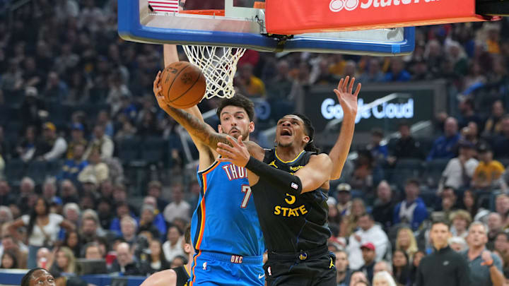 Jan 2, 2026; San Francisco, California, USA; Golden State Warriors guard Will Richard (right) shoots against Oklahoma City Thunder center Chet Holmgren (7) during the first quarter at Chase Center. Mandatory Credit: Darren Yamashita-Imagn Images