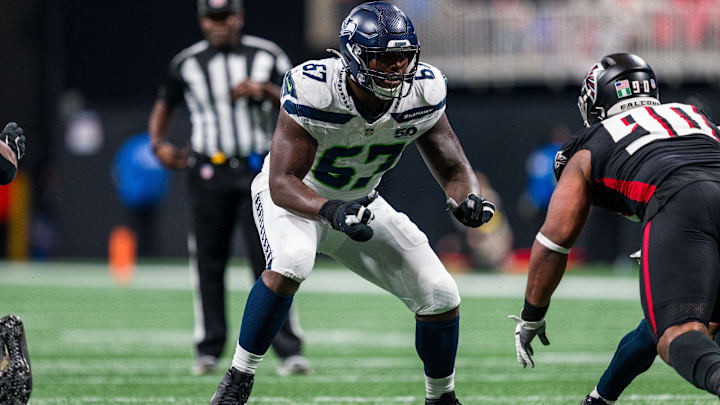 Seattle Seahawks offensive tackle Charles Cross (67) works during the second half of an NFL football game against the Atlanta Falcons, Sunday, Dec. 7, 2025, in Atlanta. Seattle Seahawks offensive tackle Charles Cross (67) works during the second half of an NFL football game against the Atlanta Falcons, Sunday, Dec. 7, 2025, in Atlanta.