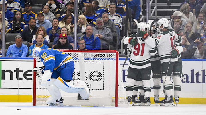 Oct 9, 2025; St. Louis, Missouri, USA; Minnesota Wild center Joel Eriksson Ek (14) is congratulated by teammates after scoring against St. Louis Blues goaltender Jordan Binnington (50) during the second period at Enterprise Center. Mandatory Credit: Jeff Curry-Imagn Images