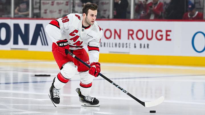 Apr 16, 2025; Montreal, Quebec, CAN; Carolina Hurricanes defenseman Domenick Fensore (89) skates with a puck during his rookie lap in warm-up before the game against the Montreal Canadiens at Bell Centre. Mandatory Credit: David Kirouac-Imagn Images