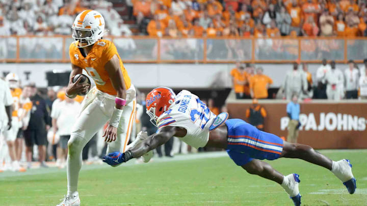 Oct 12, 2024; Knoxville, Tennessee, USA; Tennessee Volunteers quarterback Nico Iamaleava (8) runs the ball against Florida Gators edge George Gumbs Jr. (34) at Neyland Stadium. Mandatory Credit: Angelina Alcantar/USA TODAY Network via Imagn Images
