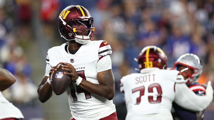 Aug 8, 2025; Foxborough, Massachusetts, USA; Washington Commanders quarterback Josh Johnson (14) drops back to pass during the first half against the New England Patriots at Gillette Stadium. Mandatory Credit: Paul Rutherford-Imagn Images